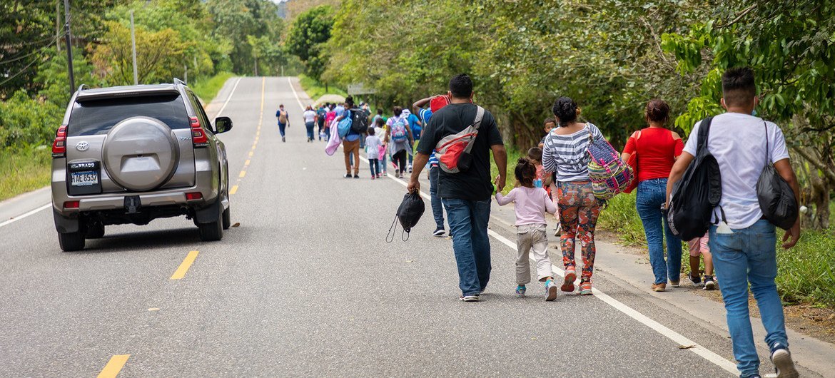 Honduran migrant families walk towards the border with Guatemala.