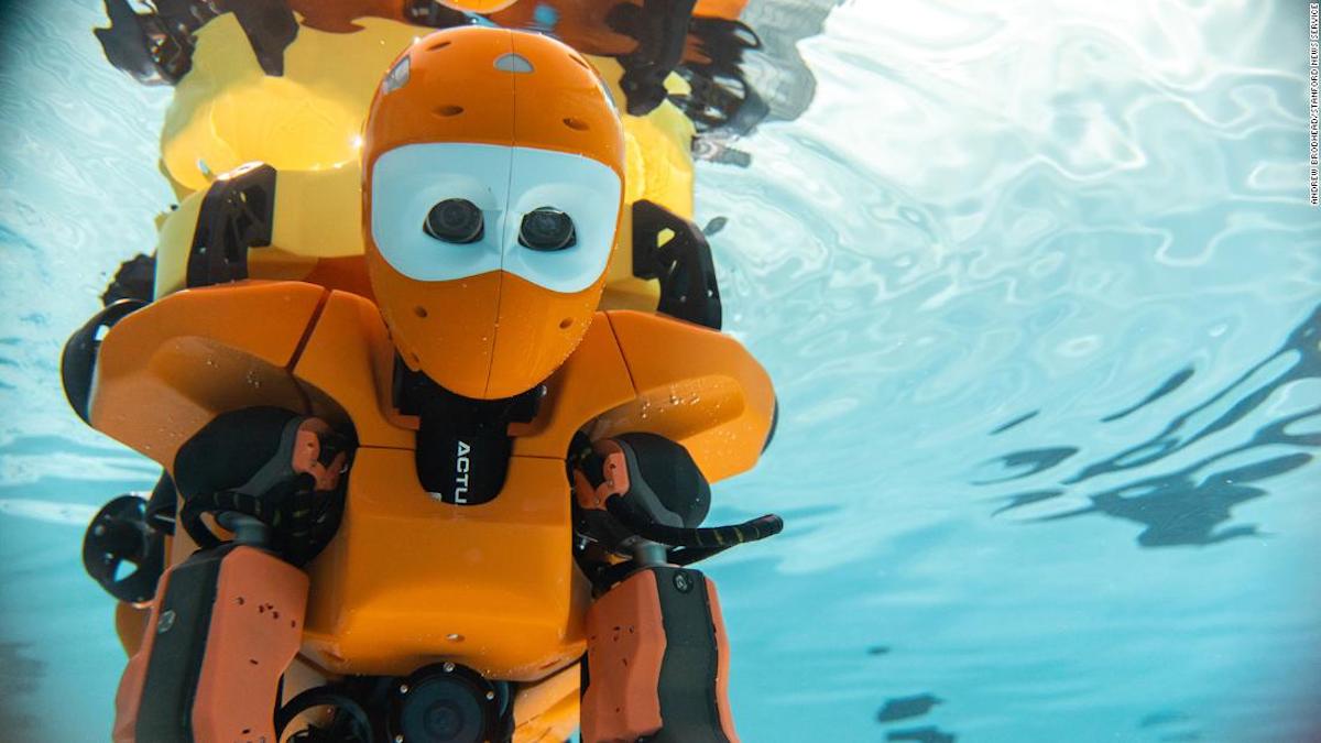 A humanoid diving robot explores shipwrecks on the ocean floor