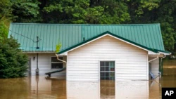 Homes flood in Lost Creek, Ky., on Thursday, July 28, 2022. Heavy rains have caused flash flooding and mudslides as storms pummel parts of central Appalachia.