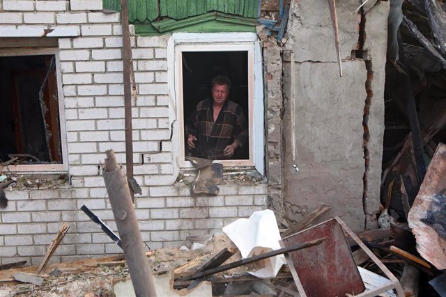 Roman Kravchenko inside the ruins of his house, destroyed by Russian multiple rocket launcher shelling, Kharkiv, northern Ukraine.