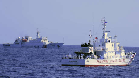 A Chinese Coast Guard ship sails near a Philippine authorities vessel.