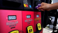 A customer uses a credit card at the pay-at-the-pump gas pump in Rolling Meadow, Ill., on Thursday, June 30, 2022.