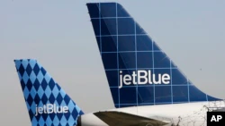 FILE - JetBlue planes are seen at New York's JFK airport in this Tuesday, Feb. 20, 2007 file photo.