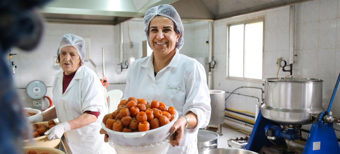 Samira Zoughaib Akiki, President of the Al Atayeb Cooperative, with a basket of fresh apple jam.