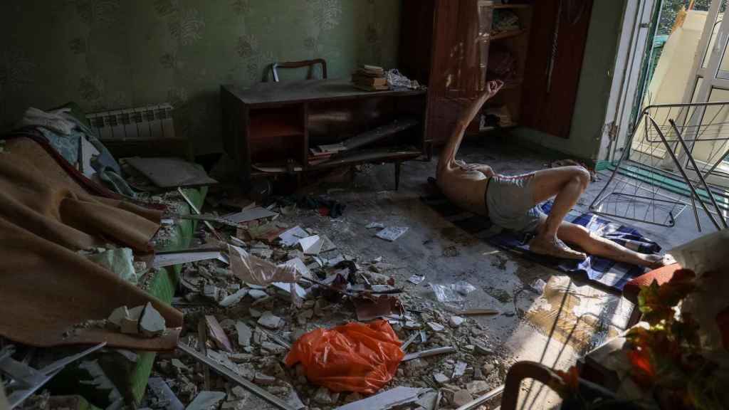 A man lying on the ground on the rubble, after the Russian attacks in Kramatorsk.