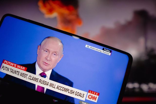 Archive - June 18, 2022, Brazil: In this photo illustration, a person watches a live broadcast of Vladimir Putin, the president of Russia, on the  TV network from the United States.  Putin provoked the West and said Russia will meet set targets