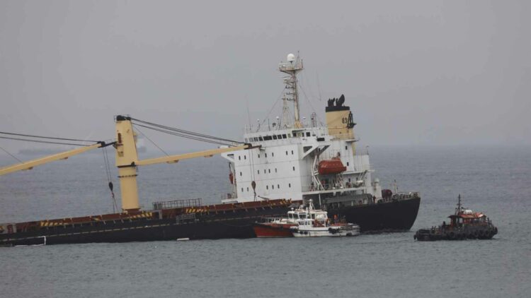 A semi-sunken ship off Gibraltar begins to pour hydraulic fluid into the sea