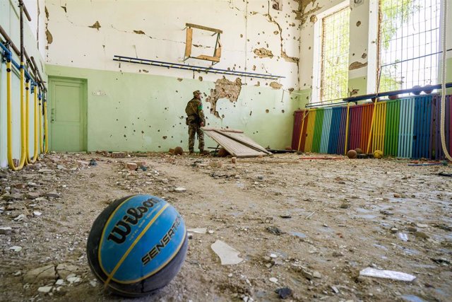 File - A Ukrainian soldier at a bombed-out school in the town of Luch, near the border with Russian-occupied Kherson province