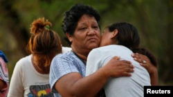 Relatives of miners trapped in a collapsed coal mine react as they wait outside the mine, in Sabinas, Coahuila state, Mexico August 14, 2022.