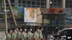 Chinese paramilitary policemen march in front of the US embassy in Beijing on Wednesday, August 3, 2022.