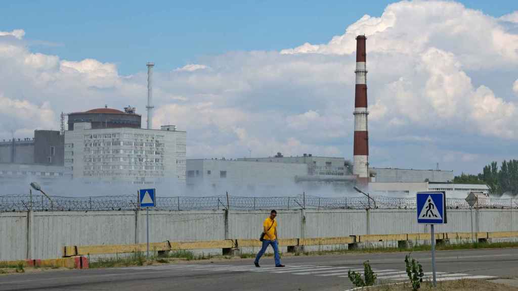 A man crosses a road near the Zaporizhia nuclear power plant in the course of the conflict between Ukraine and Russia