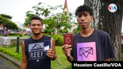 Two Venezuelans show their passports to VOA.  Photo Houston Castle