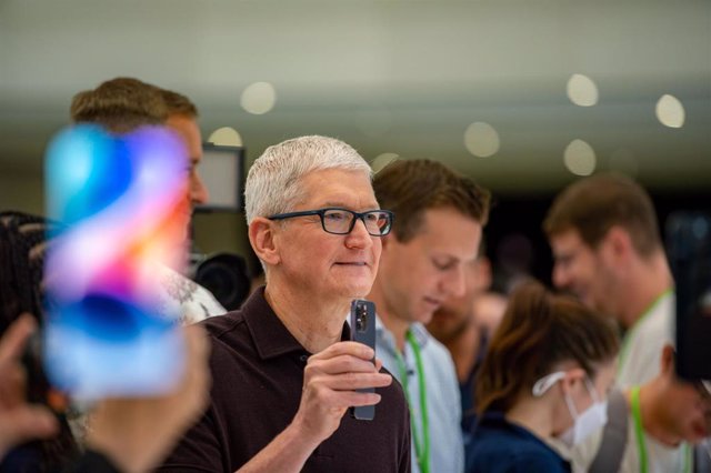 Apple CEO Tim Cook holding an iPhone 14 after the launch event on September 7, 2022