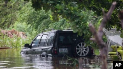 A vehicle submerges after Hurricane Fiona in Salinas, Puerto Rico, on September 19, 2022.