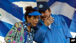 FILE - In this Sept. 5, 2018, file photo, Nicaraguan President Daniel Ortega and his wife and Vice President Rosario Murillo lead a demonstration in Managua, Nicaragua.  (AP Photo/Alfredo Zuniga, File)