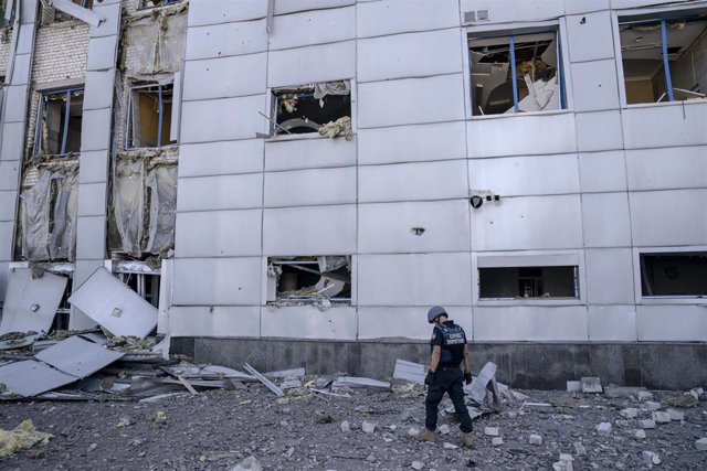 Military personnel inspect damage caused by the early morning shelling at a sports stadium in the Kholodnohirskyi district of Kharkiv, Ukraine