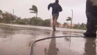 Cameraman helps family cross flood