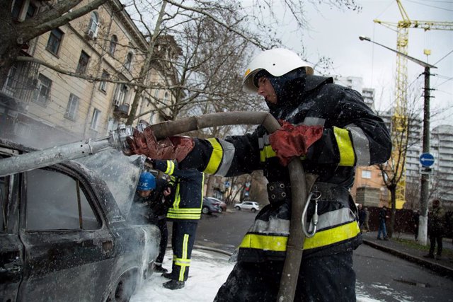 File - A firefighter extinguishes a fire in a vehicle after a Russian attack on the city of Mikolaiv, in southern Ukraine