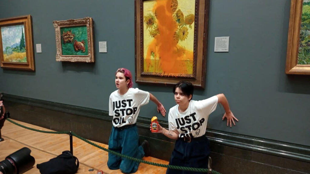 Environmental activists throw tomato soup at Van Gogh's Sunflowers