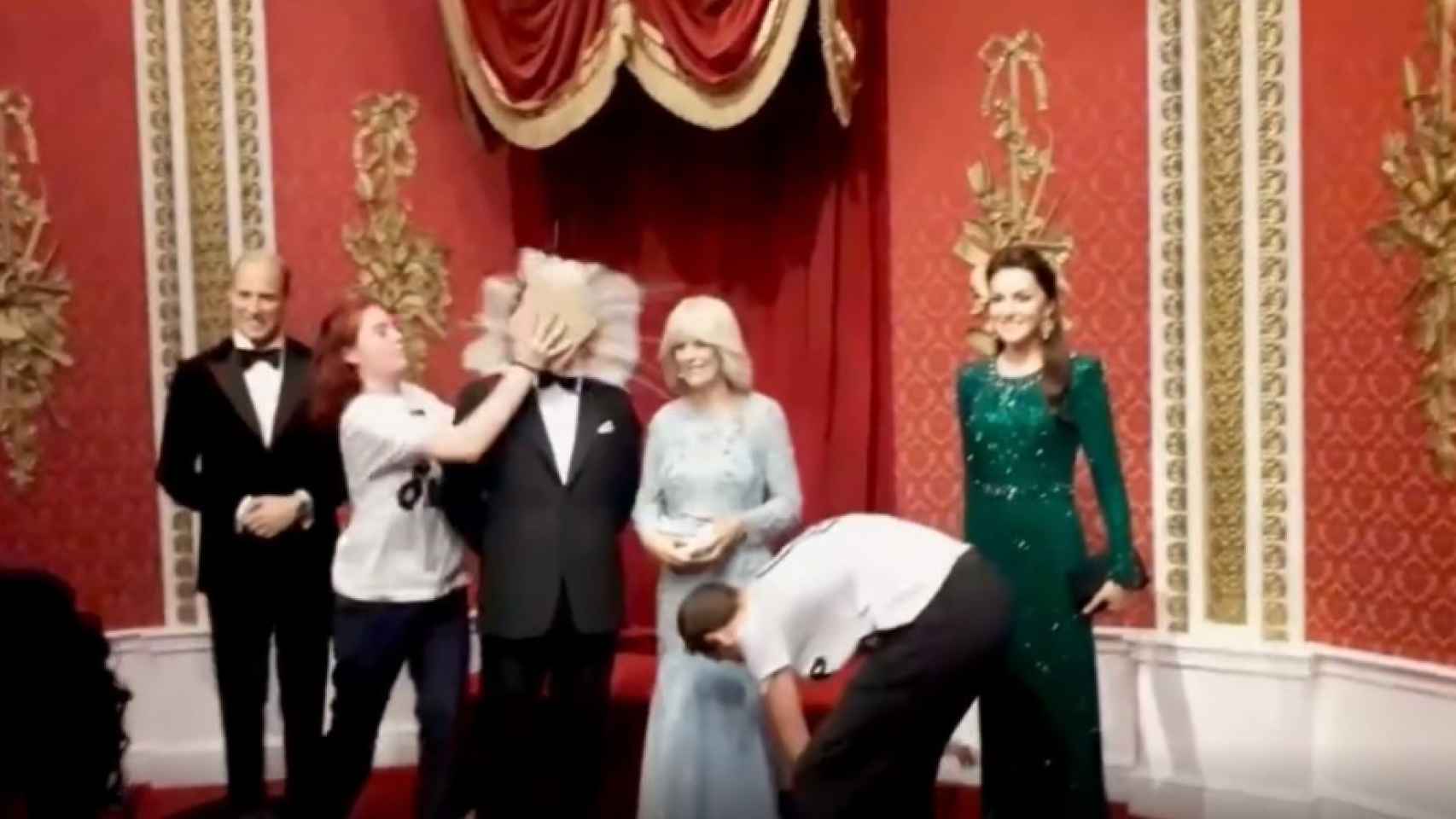 Environmentalists stamp two cakes on the wax figure of Charles III at Madame Tussauds in London