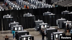 People cast their votes during early voting for the upcoming presidential election inside the Atlanta Hawks' State Farm Arena in Atlanta, Georgia, U.S., October 12, 2020. REUTERS/Chris Aluka Berry