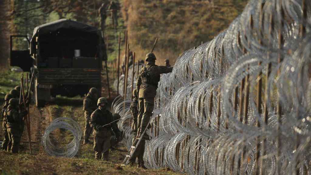 Polish soldiers install barbed wire along the Polish border with the Russian exclave of Kaliningrad.