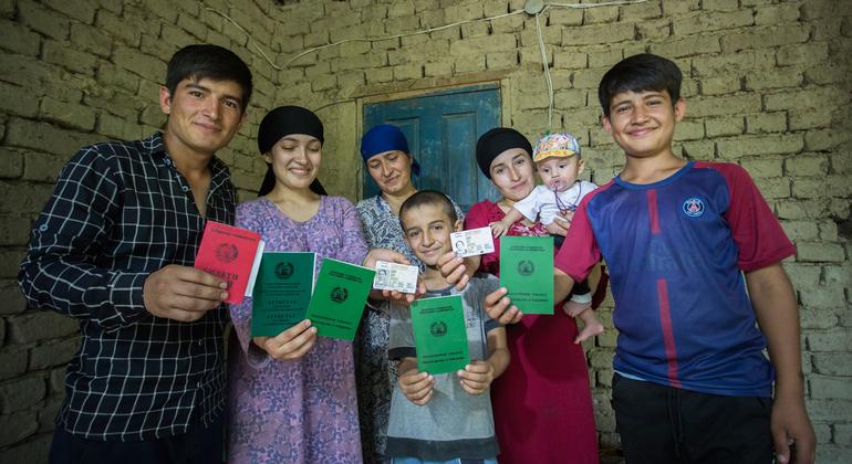 A formerly stateless family shows off their newly obtained identity documents at their home in Dushanbe, Tajikistan.