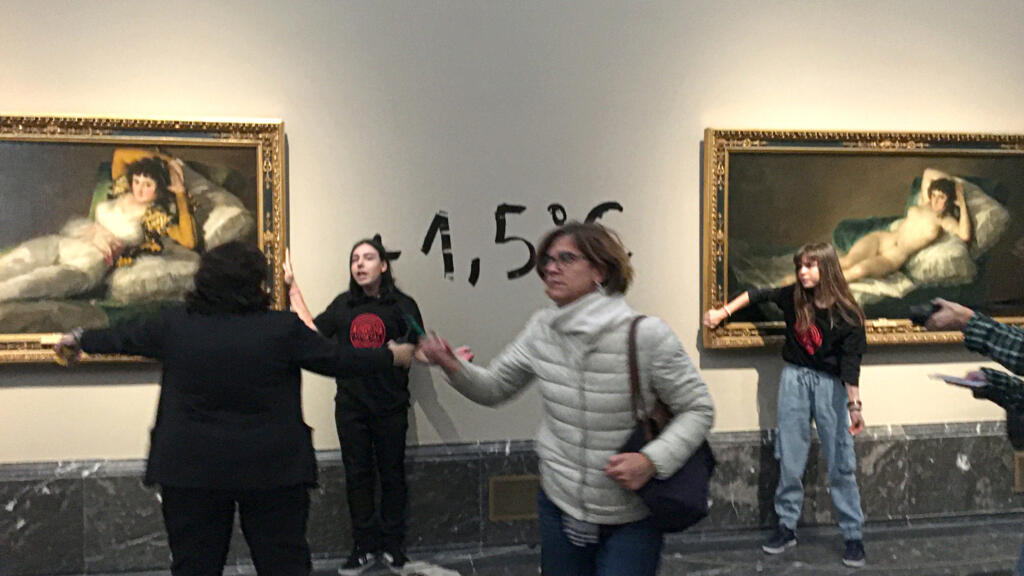 Environmental activists stick to the frame of Goya paintings in Madrid