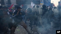 Protesters in support of Peru's President Pedro Castillo clash with law enforcement in the capital Lima on November 10, 2022.