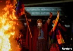 Fire burns as people celebrate in the streets after Luis Fernando Camacho, the governor of Santa Cruz and a prominent opposition leader, was detained by Bolivian police in Santa Cruz de la Sierra, in El Alto, Bolivia, on 28 February. December 2022.