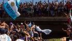 Fans jump onto Argentina players' bus, one falls to the ground