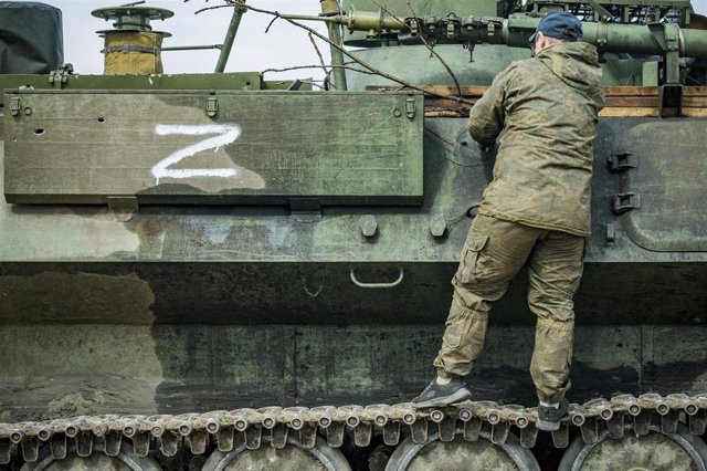 File - Ukrainian soldier in a captured armored vehicle with the Z symbol of the Russian Army in Kharkiv, Ukraine