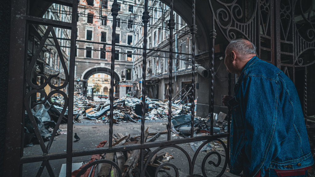 A man looks at a damaged business in Kharkiv, Ukraine.