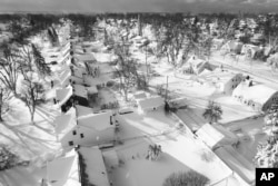 In this drone image, snow covers a neighborhood, Sunday, December 25, 2022, in Cheektowaga, NY