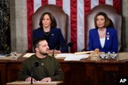 Ukrainian President Volodymyr Zelenskyy looks at the guests of the Ukrainian delegation as he addresses Congress on Capitol Hill in Washington, Wednesday, December 21, 2022.