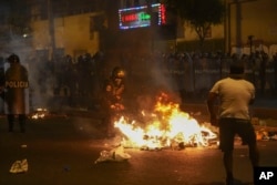 Police clear a street during anti-government protests in Lima, Peru, Friday, January 20, 2023.