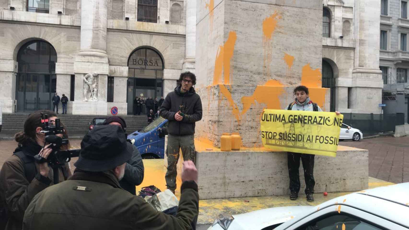 An environmental group throws paint at a sculpture in front of the Milan Stock Exchange