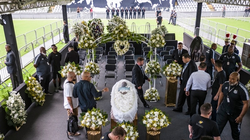 Brazilians parade in front of Pele's coffin at Santos stadium