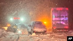 In this image taken on Saturday, December 31, 2022 and released by California Highway Patrol Truckee, stranded vehicles along Interstate 80 at the Nevada and Colfax, California state line.