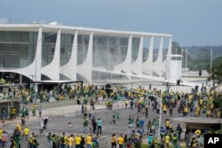 Supporters of former Brazilian President Jair Bolsonaro protest outside the Planalto Palace in Brasilia, Brazil, Sunday, January 8, 2023.