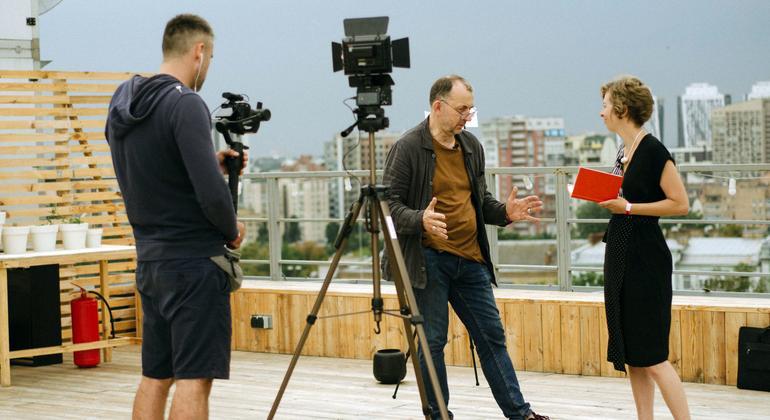 Journalists working on a rooftop in Kyiv, Ukraine