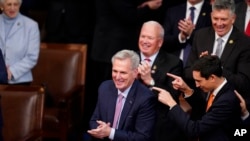 US Representative Kevin McCarthy, R-Calif., smiles after winning the 15th ballot in the House of Representatives on the fifth day of trying to elect a president and convene the 118th Congress in Washington, on January 7, 2023.