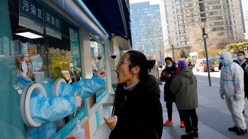 A health worker performs a coronavirus test in Beijing.