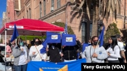 Members of the United Border Workers organization show solidarity with migrants gathered around the Sacred Heart Church in El Paso, Texas, on January 8, 2023.