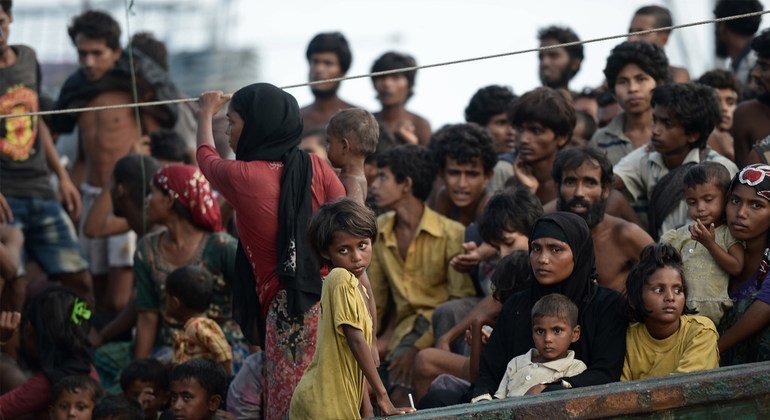 Stranded Rohingya sit on the deck of an abandoned smuggler ship adrift in the Andaman Sea in 2015.