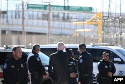 US President Joe Biden speaks with US Customs and Border Protection police at the US-Mexico Bridge of the Americas border crossing in El Paso, Texas on January 8, 2023.