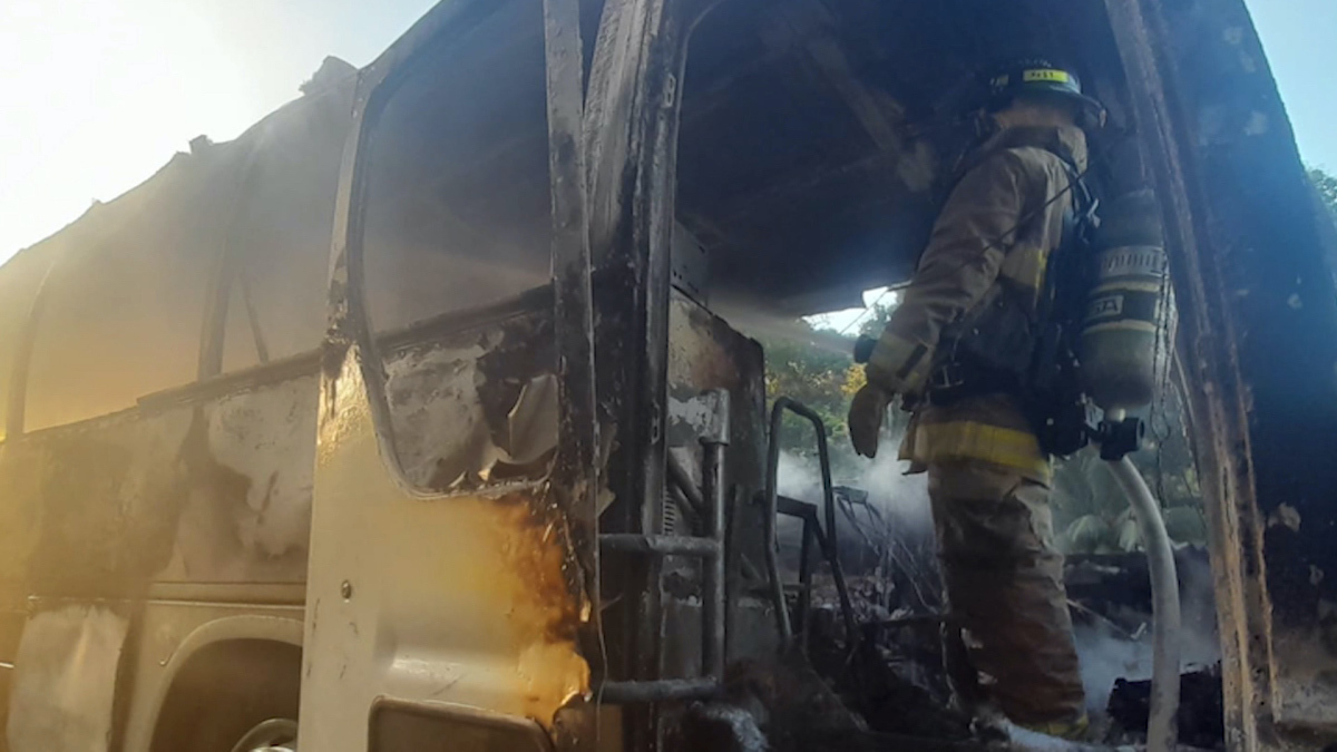 Firefighters putting out the fire on a migrant bus in Panama.