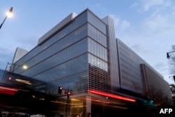 Vehicles drive past the World Bank headquarters in Washington, DC, on January 10, 2022. (Photo by Stefani Reynolds/AFP)