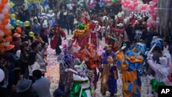 Contestants dressed as Carnival character Pepino display dance moves during a competition to choose the three main Carnival characters - Chuta, Pepino and Chola - in La Paz, Bolivia, Friday, February 10, 2023. The royal trio of Carnival must be an expert in spreading happiness and not get tired of dancing.  (AP Photo/Juan Karita)