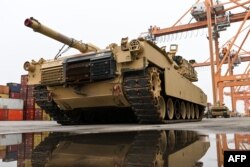 A US Army M1A2 Abrams battle tank that will be used for military exercises by the 2nd Armored Brigade Combat Team, is unloaded at the Baltic Container Terminal in Gdynia, Poland, on December 3, 2022. .